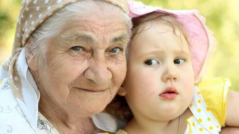 Grandmother and granddaughter play and hug Stock Footage
