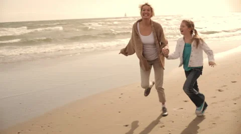 Grandmother and granddaughters walking on the beach together