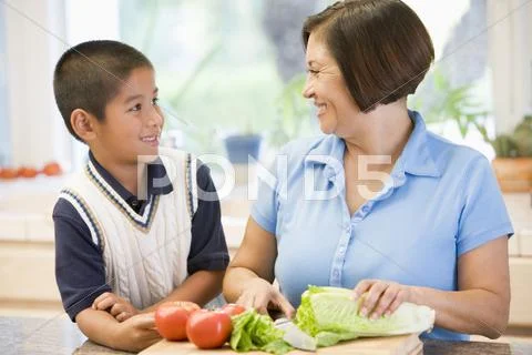 Grandmother and grandson preparing meal,mealtime together Stock Photos