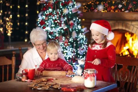Grandmother and kids bake Christmas cookies. Stock Photos