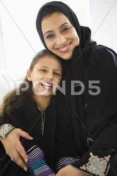 Grandmother with grandaughter in living room smiling Stock-Fotos