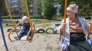 Grandmother With A Grandson On A Swing Stock Footage
