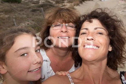 Grandmother with her daughter and grand daughter looking at the camera Stock Photos