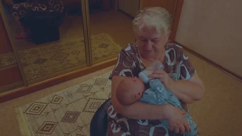 Grandmother with an infant Stockbeeldmateriaal 337322295