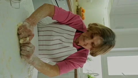 Grandmother is preparing dough in the kitchen. Selective focus. Stock Footage 171483772