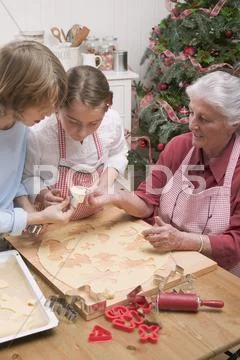 Grandmother Showing Grandchildren Cut-Out Christmas Biscuit