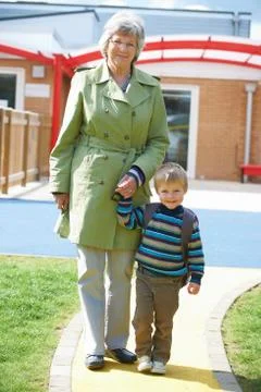 Grandmother Taking Grandson To School Stock Photos