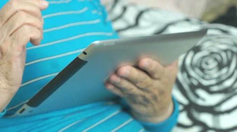 Grandmother uses the new computer tablet Stock Footage 67725231