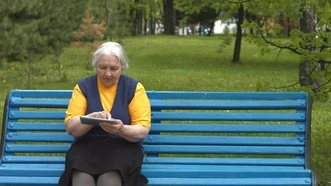 Grandmother uses a tablet computer. 2 Shots. Stock Footage 76016630