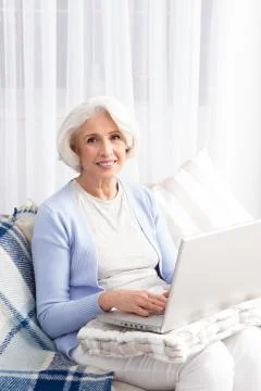 Grandmother using laptop computer Stock Photos