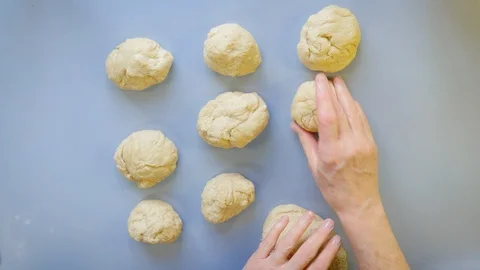 Grandmotherly Baker Rolling Out Bread Buns on a Rustic Farmhouse Kitchen Counter Stock Footage 87628167