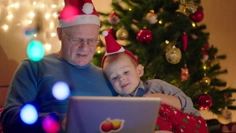 Grandpa and grandson using notebook on New Years Eve Stock Footage 73040805
