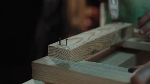 Grandpa carpenter makes a window with his Stock Footage 100548382