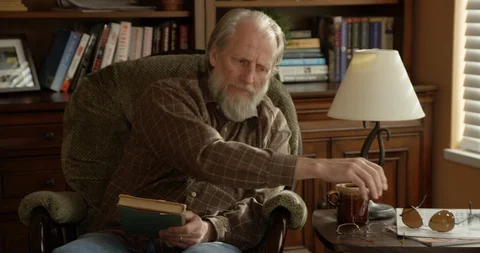 Grandpa grabs wrong glasses - 4K Stock Footage 89823699