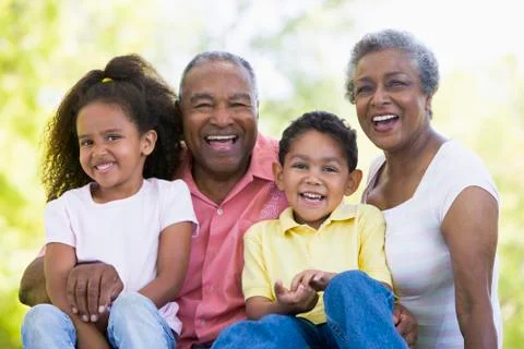 Grandparents laughing with grandchildren. Stock Photos