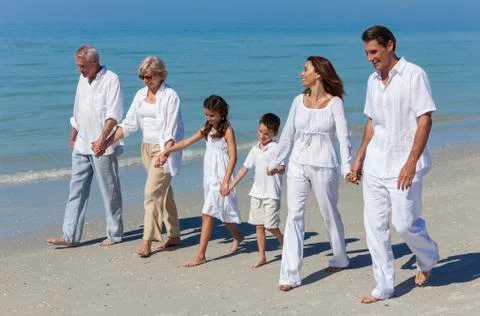 Grandparents, mother, father children family walking beach Stock Photos
