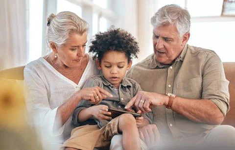 Grandparents, phone and child in home pointing, learning and bonding together in Stock Photos