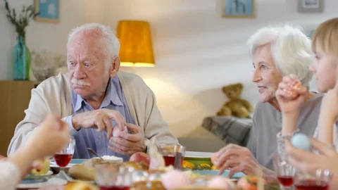 Grandparents Talking to Grandson at Easter Dinner Stock Footage 106630742