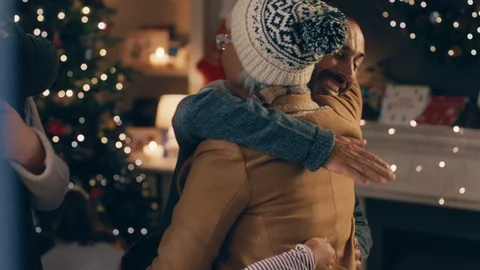Grandparents visiting for christmas eve hugging family enjoying festive holiday Stock Footage