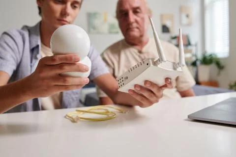 Grandson Installing Surveillance Camera Stock Photos