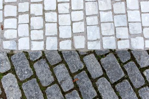 Granite and white marble cobblestone pavement texture background top view Stock Photos