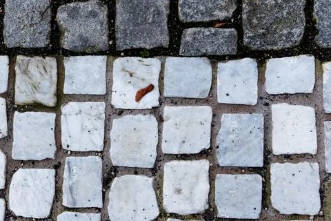 Granite and white marble cobblestone pavement texture background top view Stock Photos