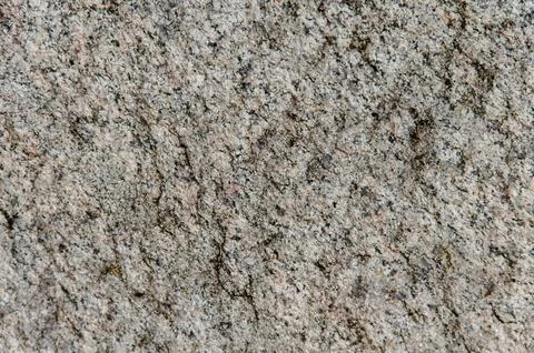 Granite background. The wall of the old building. Close-up. Stock Photos
