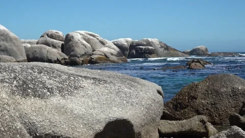 Granite beach boulders rolling waves and kelp in the sea Stock Footage 312794320