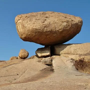 Granite boulder balancing on a edge Stock Photos