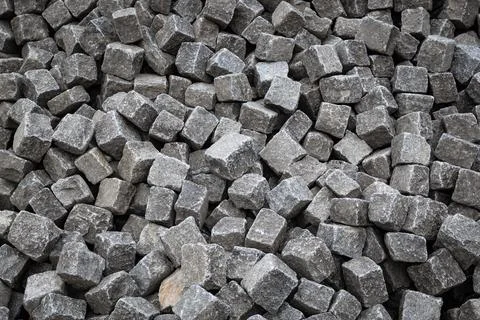 Granite cobblestone blocks background. Pile of square pavement stones Stock-Fotos