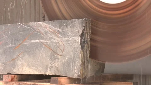 Granite cooled with water while being cut Stock Footage 254324637