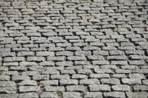 Granite gray cobblestone pavement abstract background Stock Photos