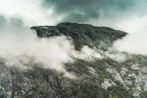 Granite Mountain Covered by Low Elevated Clouds. Norwegian Landscape. 스톡 사진