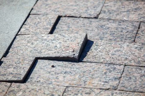 Granite pavers arranged in angular design with natural stone texture Stock Photos