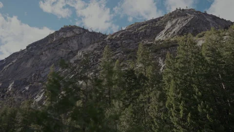 Granite peak and pine forest under clouds Yosemite Stock Footage 347986492