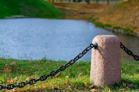 Granite posts with a large iron chain Stock Photos
