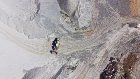 Granite quarry activity with trucks and machinery working in the extraction area Stock Footage 344776024