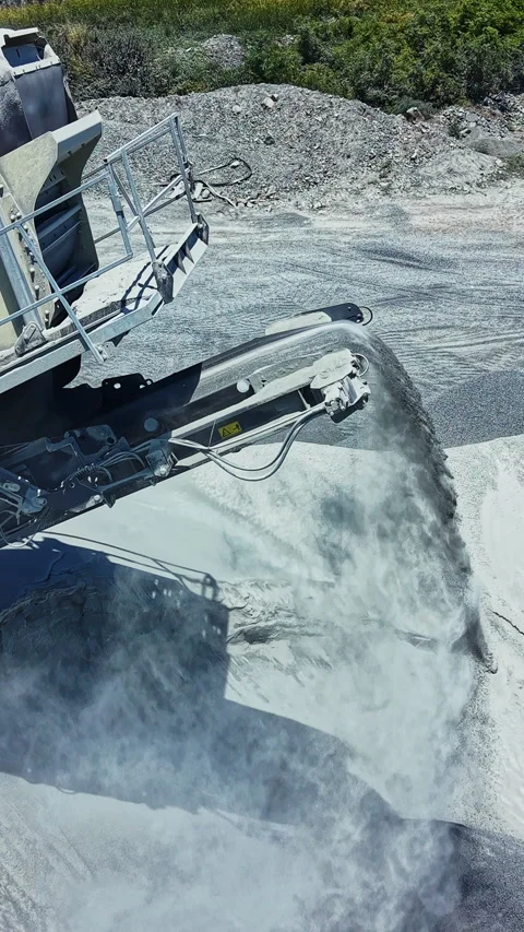 Granite quarry equipment processes stone at a site in the daytime with dust Stock Footage 337906566