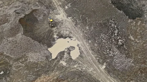 Granite quarry located in a rugged area where heavy machinery is used for mining Stock Footage 331074235
