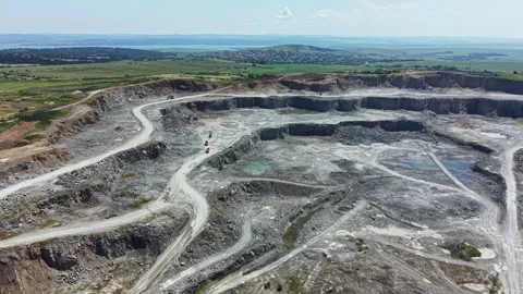 Granite quarry located in a rural area with machines working during the day near Stock Footage 337911322