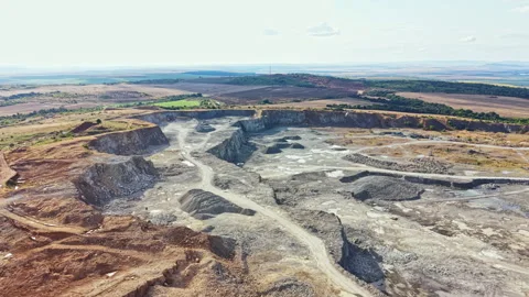 Granite quarry located in a rural area showing large excavated sections and Stock Footage 340935728