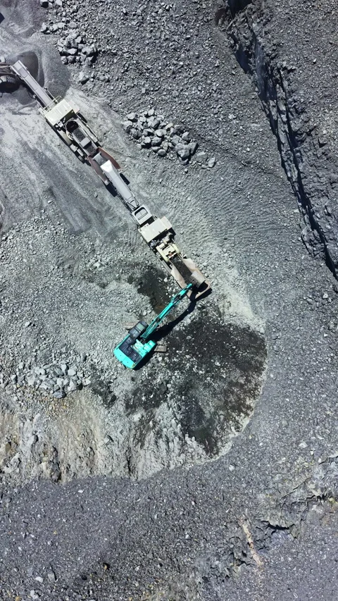 Granite quarry operation with machinery extracting stone and transporting Stock Footage 337885406
