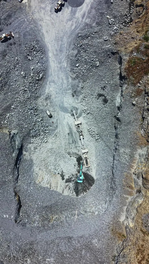 Granite quarry operation in a mining area during daytime showing machinery and Stock Footage 339498079