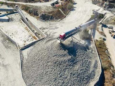 Granite quarry operations include crushing and transporting stone in a busy.. Stock Photos