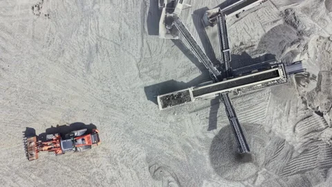 Granite quarry operations in a large site with machinery moving materials and Stock Footage 340179821