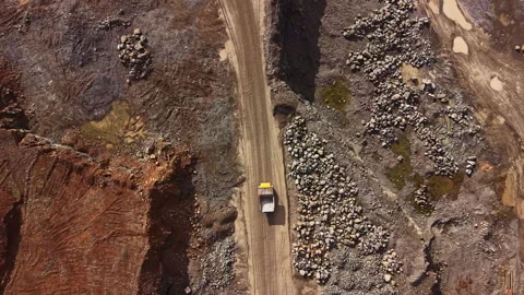 Granite quarry operations at a mining site with heavy machinery and natural Stock Footage 335412574