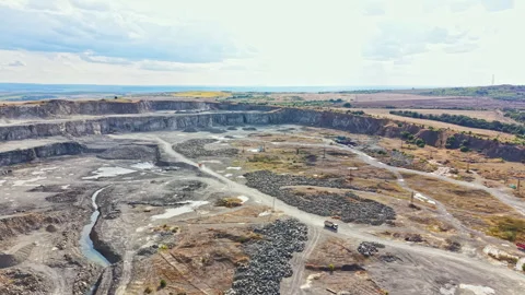 Granite quarry in a remote area shows large machinery and rocky surfaces under a Stock Footage 340936857