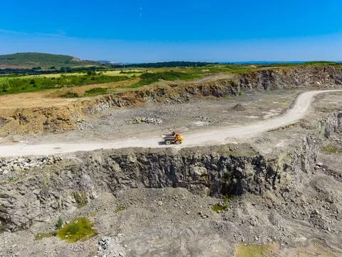 Granite quarry showing a large dump truck on a dirt road in a rocky landsca.. Stock Photos