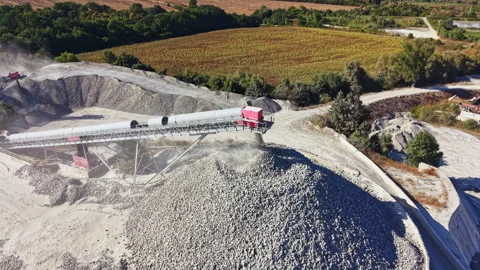 Granite quarry shows extraction and processing of stone materials during a sunny 動画素材 344798189