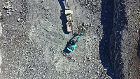 Granite quarry shows machinery working on stone extraction in a large open pit Stock Footage 341091372